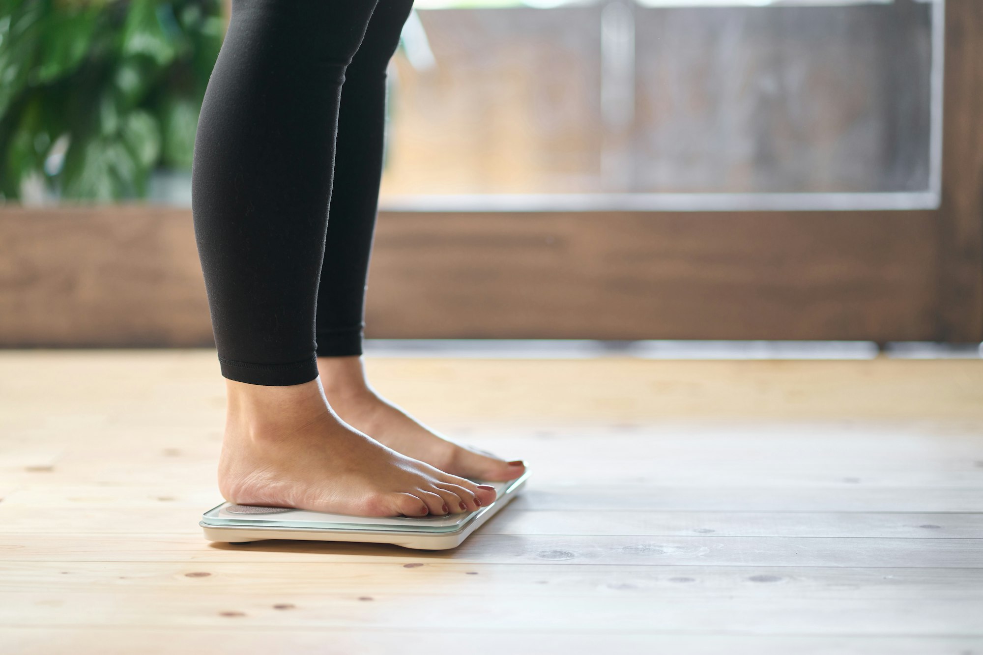 Feet of an Asian woman on a weight scale